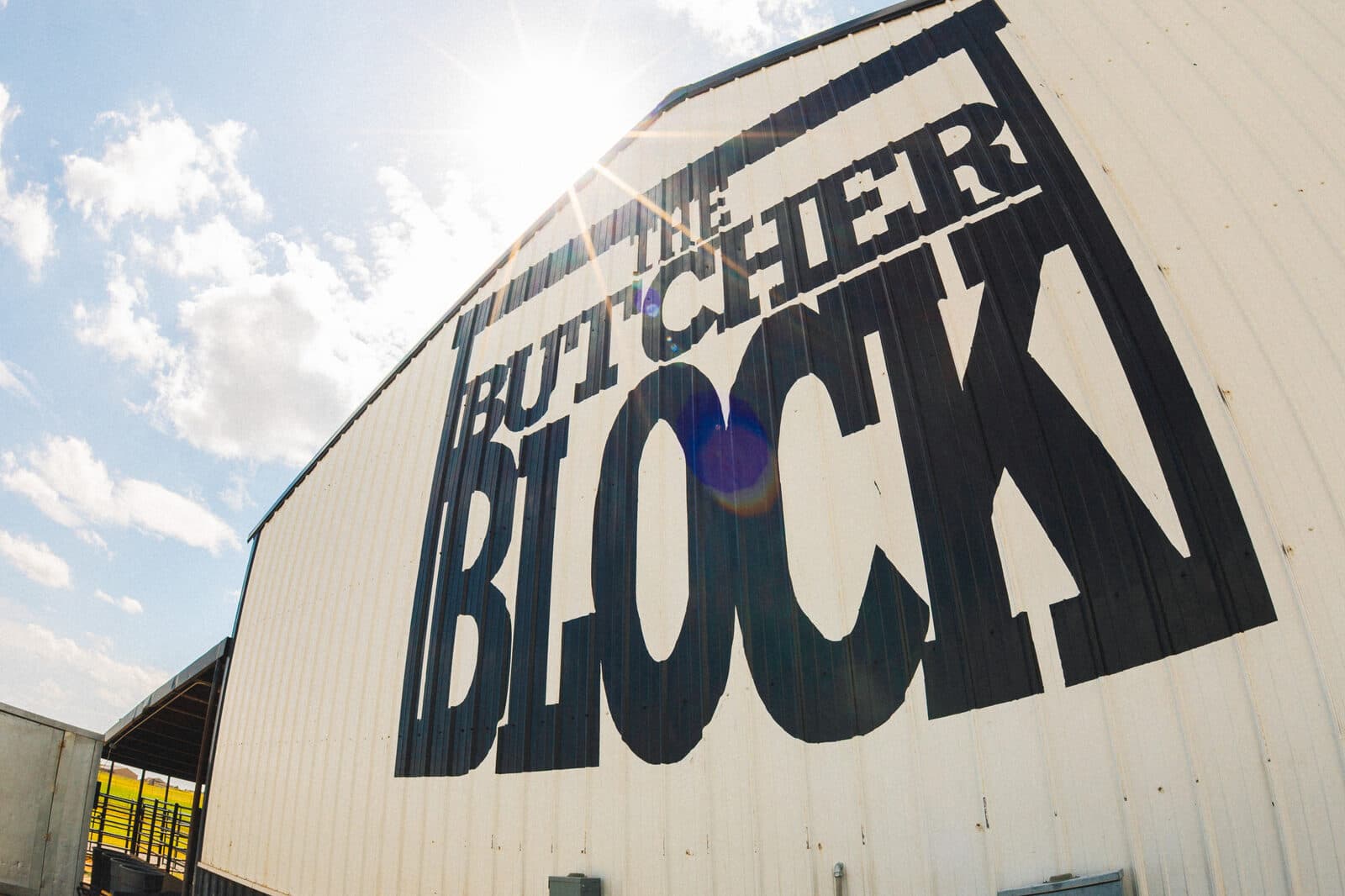 The Butcher Block sign on the side of the building under a bright Oklahoma sky